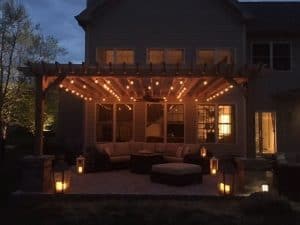 Pergola with lights outside house for holiday decorations