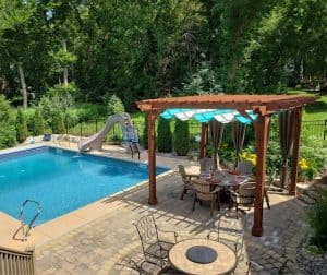 Covered pergola with canopy outside of pool