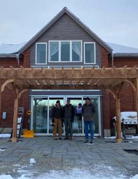 a cedar pergola in the snow