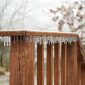 icicles on a wood railing