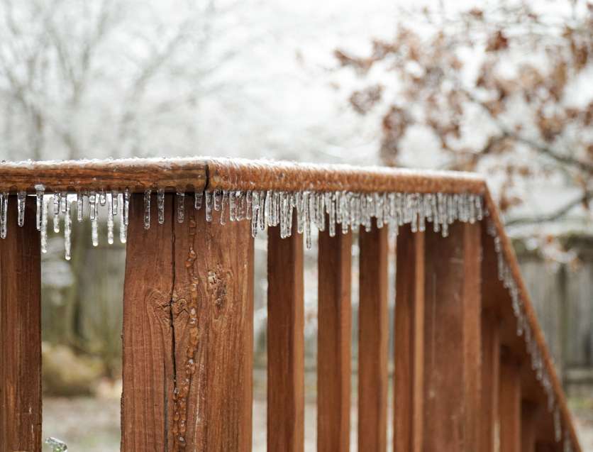 icicles on a wood railing